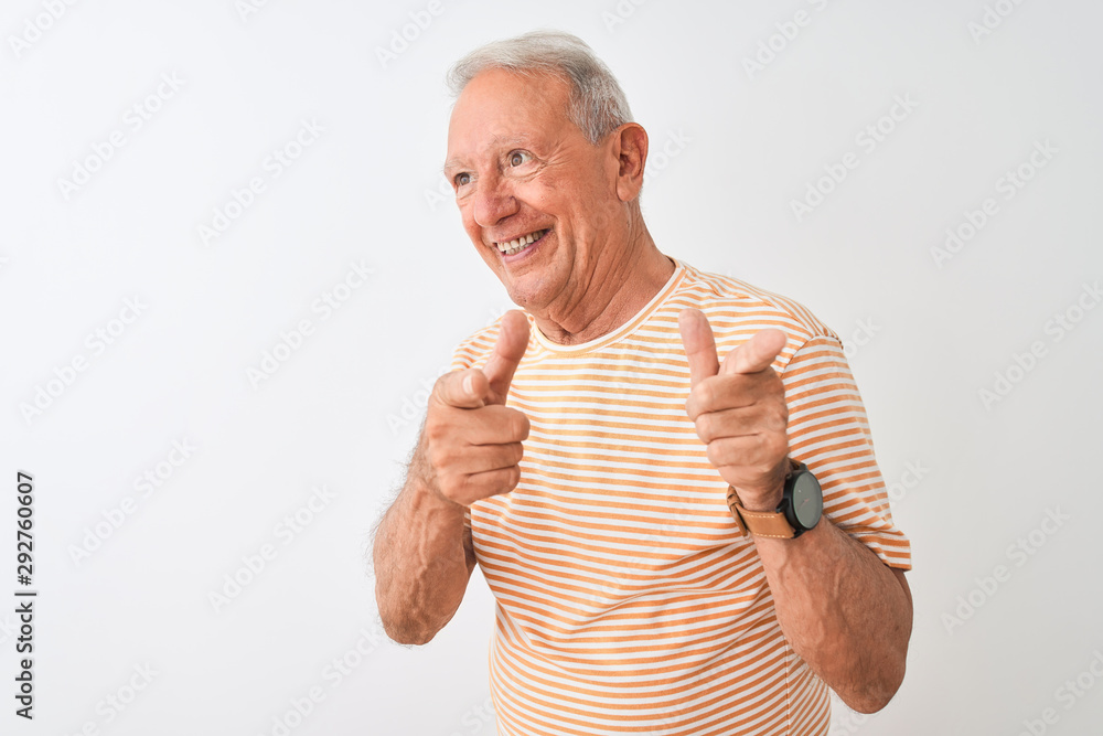 Senior grey-haired man wearing striped t-shirt standing over isolated white background pointing fingers to camera with happy and funny face. Good energy and vibes. Senior grey-haired man wearing striped t-shirt standing over isolated white background pointing fingers to camera with happy and funny face. Good energy and vibes.