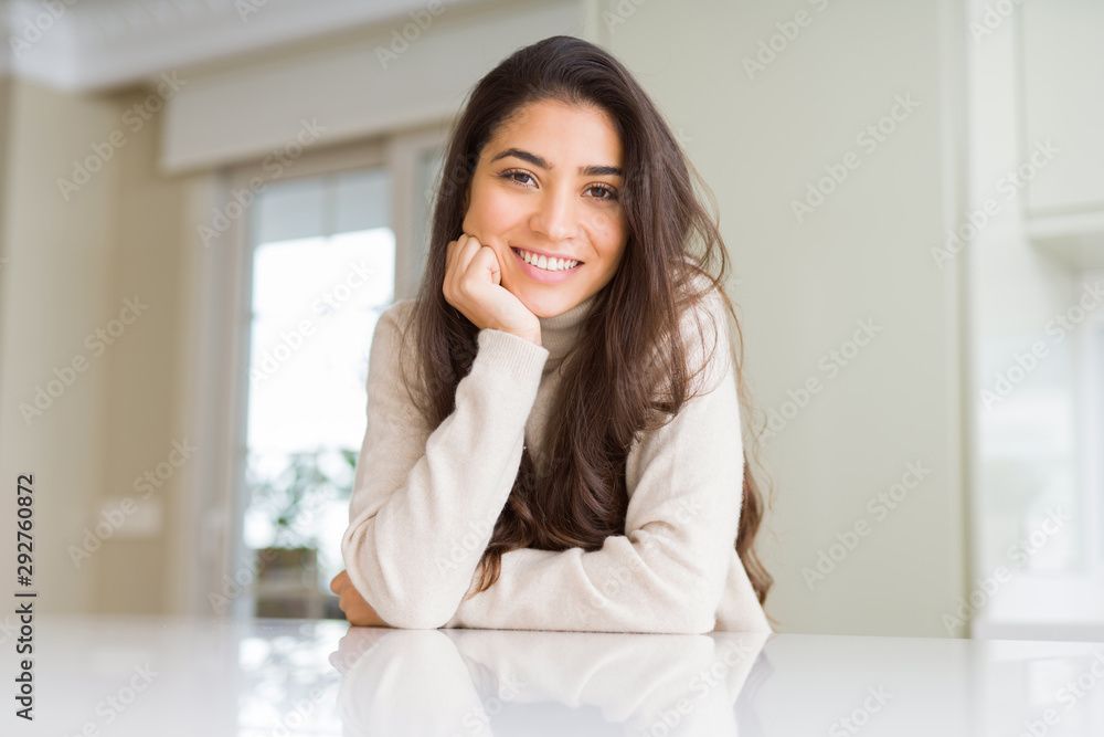 Beautiful brunette woman smiling cheerful with big smile, looking positive and happy with crossed arms Beautiful brunette woman smiling cheerful with big smile, looking positive and happy with crossed arms