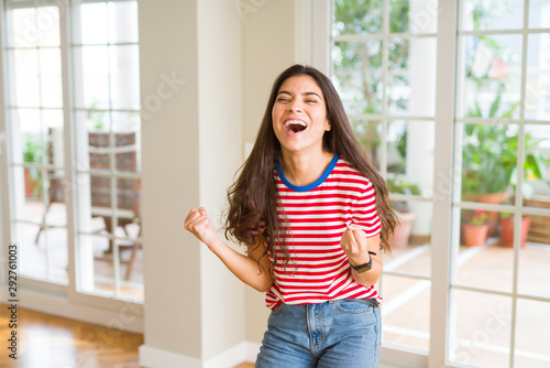 Beautiful young woman celebrating excited for success, screaming and smiling for winning