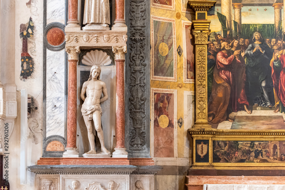 Saint Sebastian statue decorating interior of catholic church in Italy
