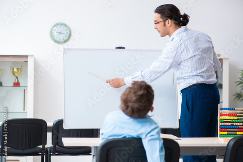 Young father helping his son to prepare for exam