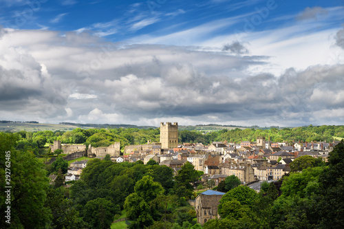 Historic market town of Richmond in North Yorkshire England with Norman Richmond Castle in sun with cloudy sky