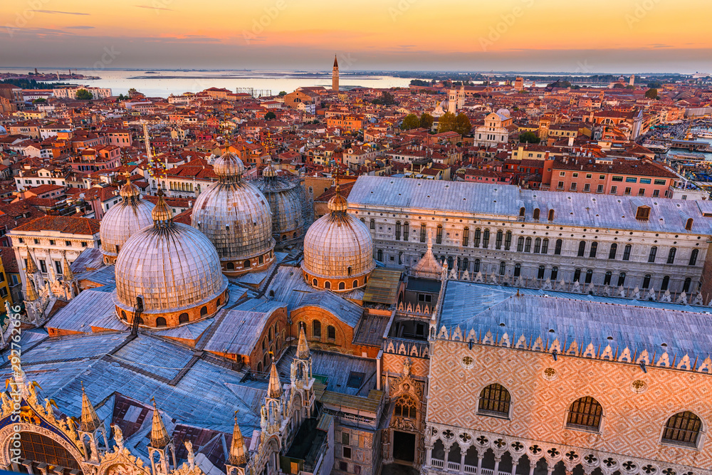 Aerial view of domes of Basilica di San Marco and Doge's Palace (Palazzo Ducale) in Venice, Italy. Architecture and landmark of Venice. Sunset skyline of Venice.