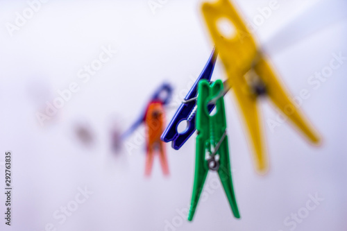 clothes pegs on blue background