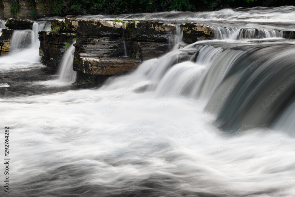 Fototapeta premium Long exposure with blurred water of River Swale Waterfalls in Richmond North Yorkshire England