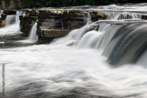 Long exposure with blurred water of River Swale Waterfalls in Richmond North Yorkshire England