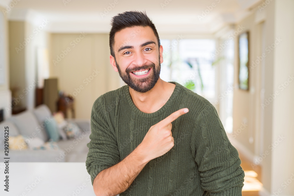 Plakat Handsome man pointing with arms and fingers, smiling cheerful with big smile on face