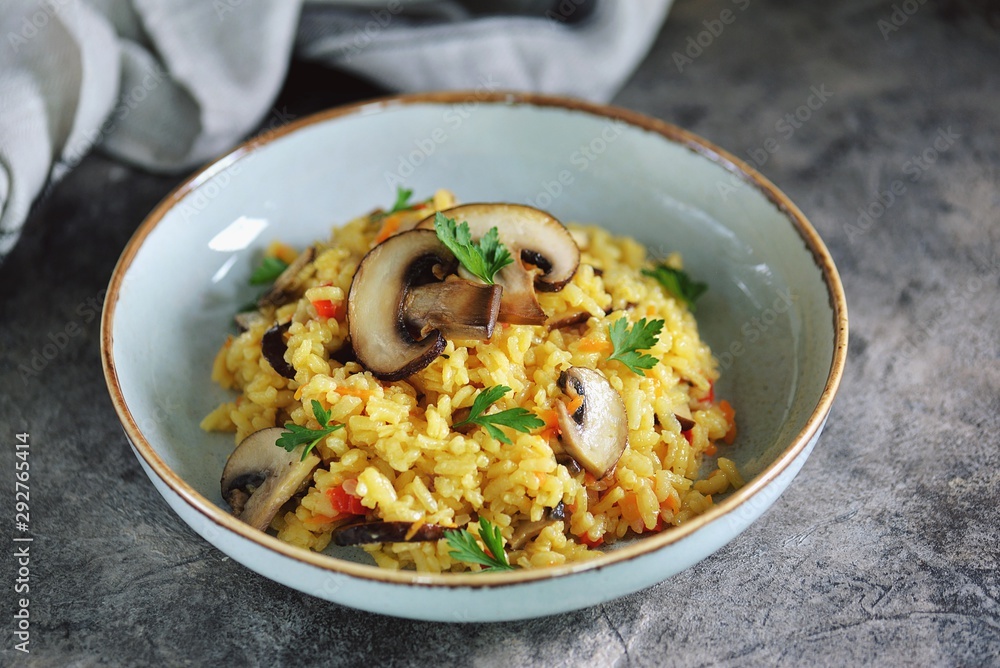 Paella or risotto with mushrooms, bell peppers, carrots, onions, white wine and olive oil. Homemade healthy food.