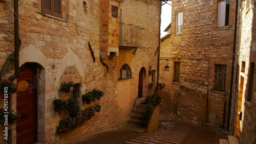 Walking along the picturesque Via Santa Croce, also known as Zu den Deutschen Schwestern von S. Croce, in Assisi, Umbria, Italy