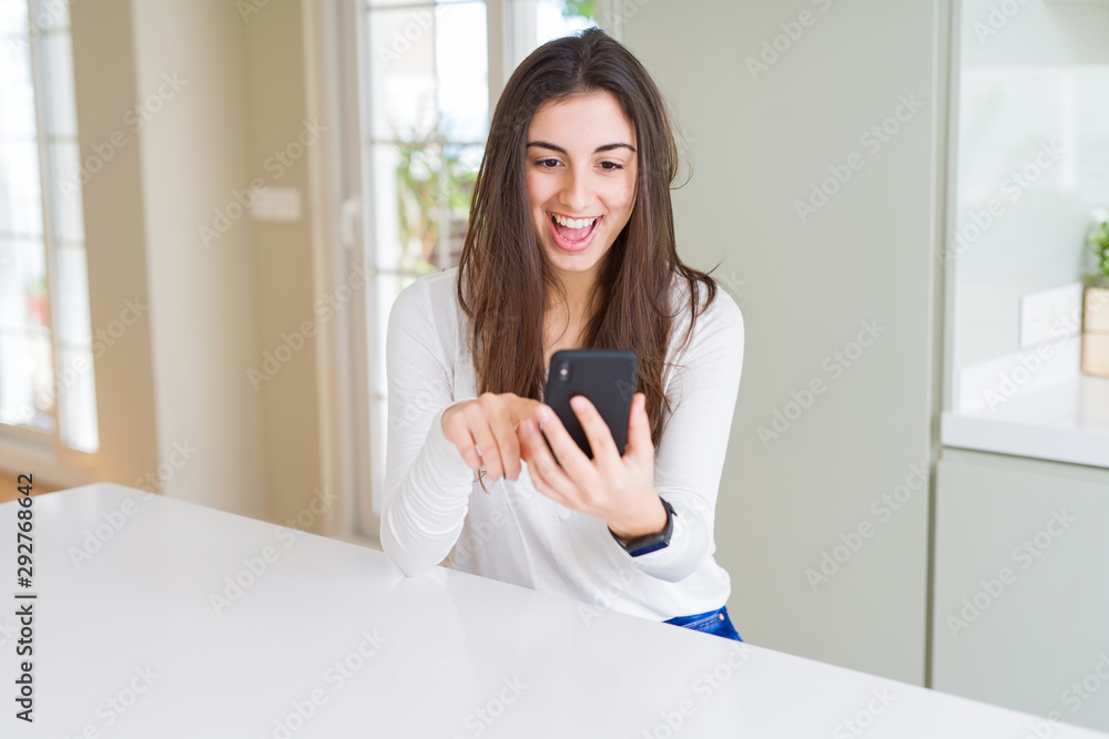 Young woman using smartphone, smiling happy texting and typing Young woman using smartphone, smiling happy texting and typing