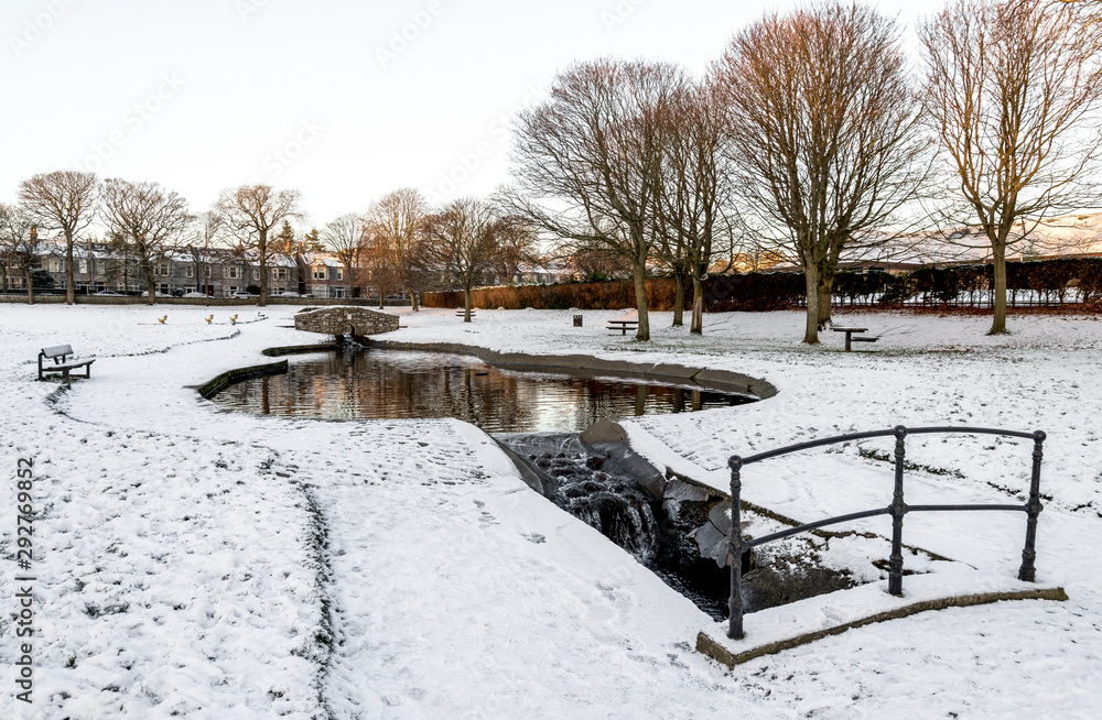 A small artificial pond and river in Westburn park during winter season, Aberdeen, Scotland
