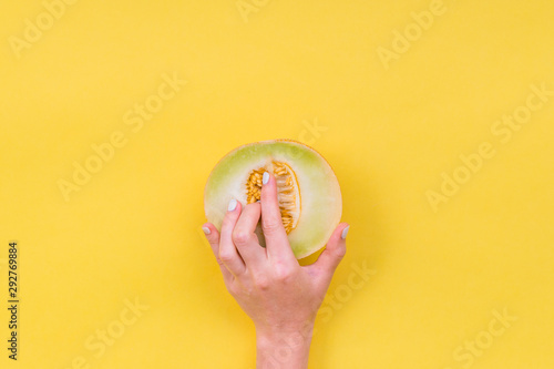Hand in the melon cut. Melon seeds in a cut. Easy eroticism. Sex concept.