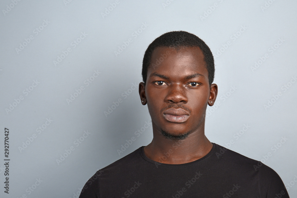 Handsome African-American man on grey background Handsome African-American man on grey background