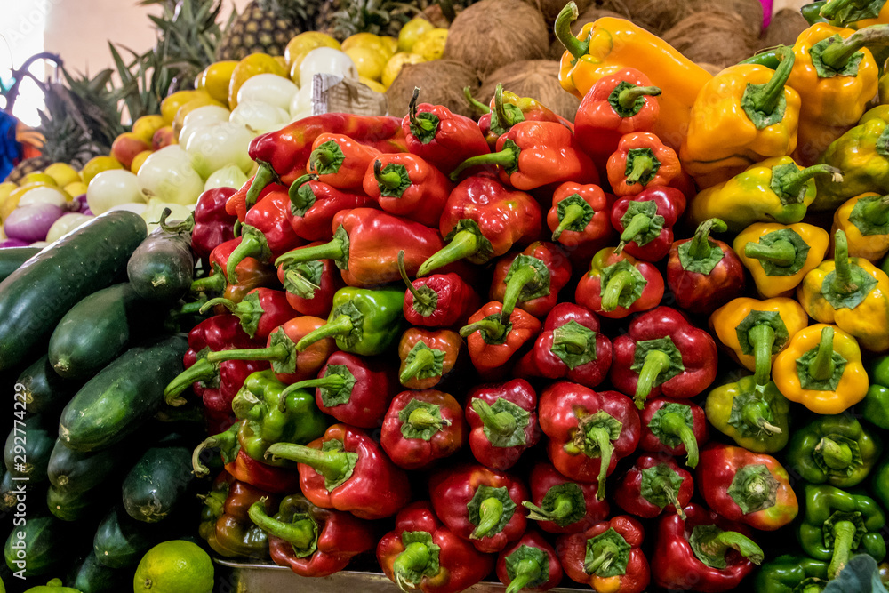 Piles of red peppers and vegetables in a Cuenca market in Ecuador.