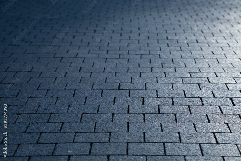 Dark grey granite rectangular pavement close-up texture background
