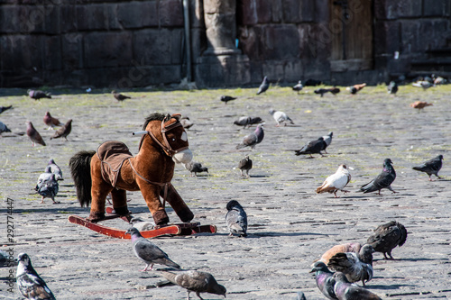 Small rocking horse waits for its young owner in the square in front of the San Francisco Church in the center of Quito photo