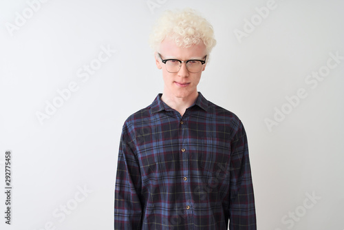 Young albino blond man wearing casual shirt and glasses over isolated white background skeptic and nervous, frowning upset because of problem. Negative person.