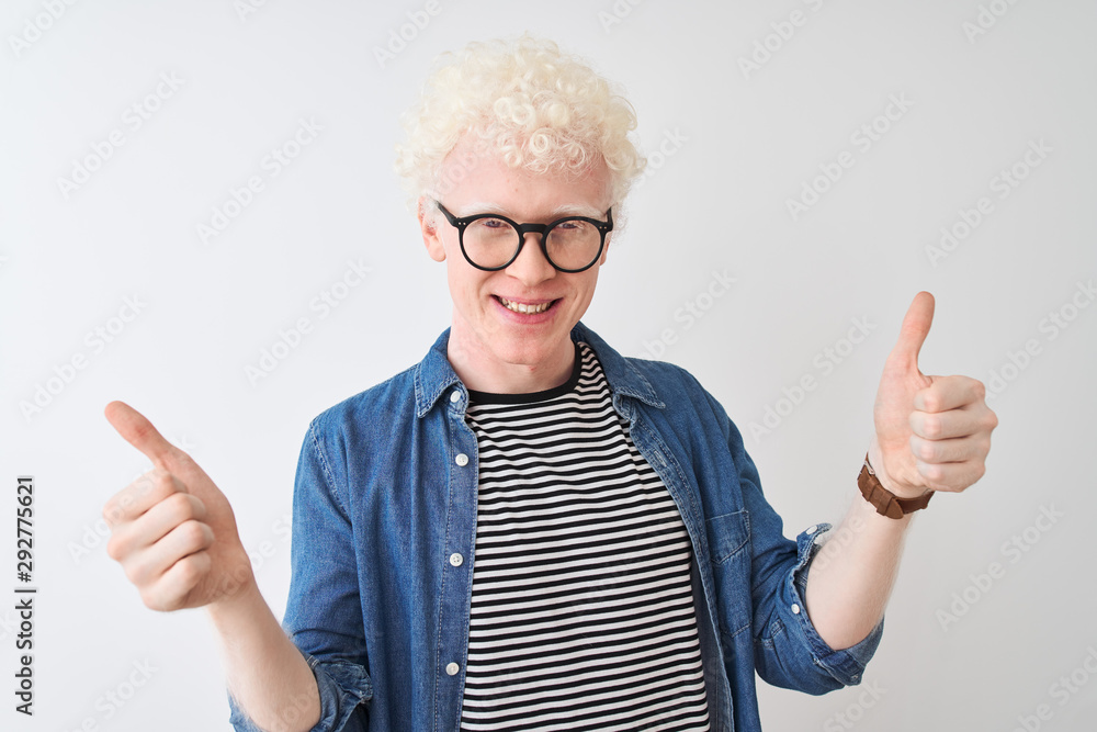 Young albino blond man wearing denim shirt and glasses over isolated white background smiling confident pointing with fingers to different directions. Copy space for advertisement Young albino blond man wearing denim shirt and glasses over isolated white background smiling confident pointing with fingers to different directions. Copy space for advertisement
