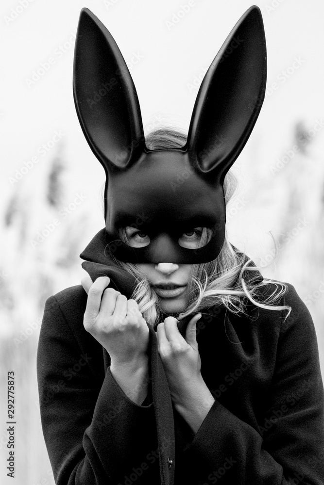 Beautiful blonde woman with scared face in black bunny mask Stock Photo |  Adobe Stock