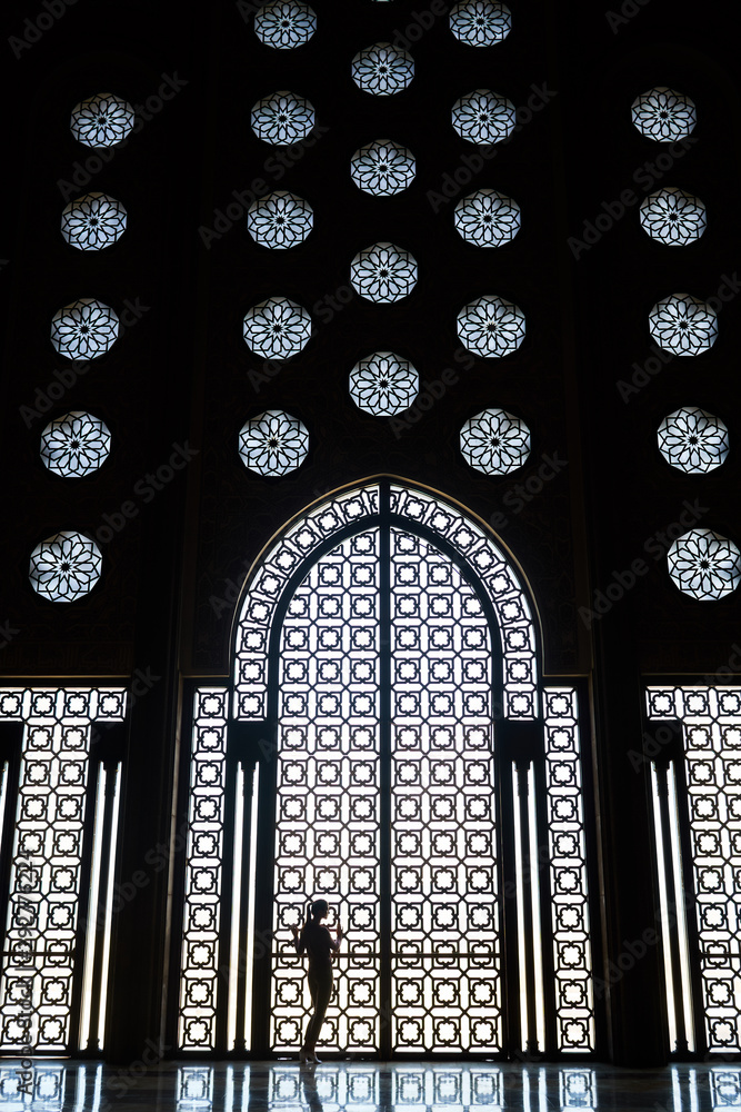 Female silhouette, window with ornaments, Hassan II Mosque in Casablanca, Morocco.    