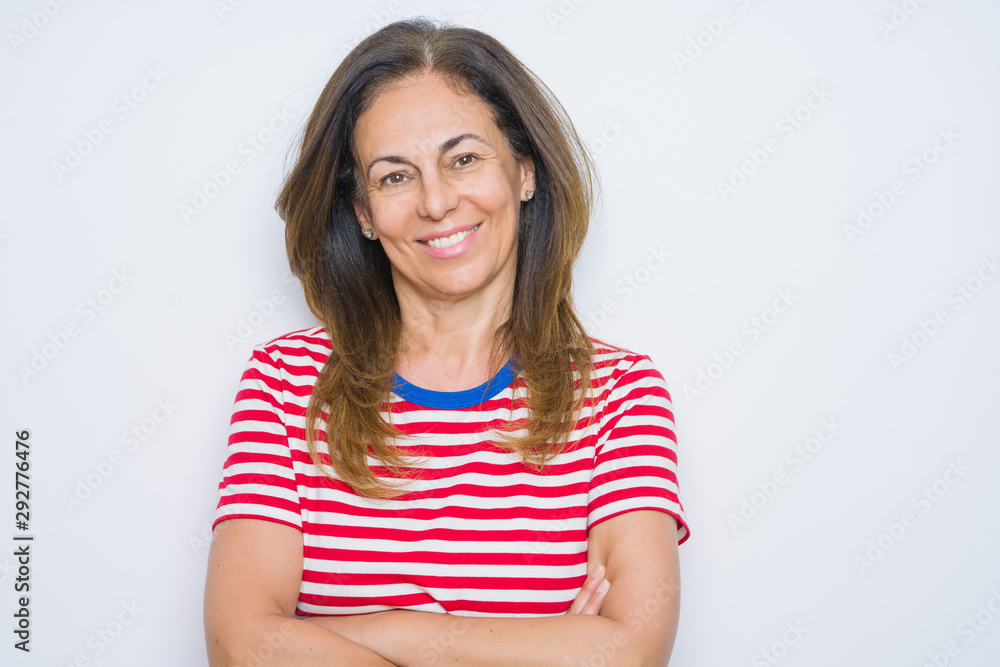 Middle age senior woman standing over white isolated background happy face smiling with crossed arms looking at the camera. Positive person. Middle age senior woman standing over white isolated background happy face smiling with crossed arms looking at the camera. Positive person.