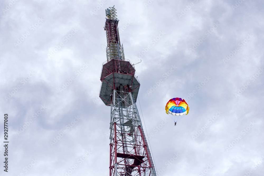 Parachutists jumping down from a big antenna. Sport and recriation. Parachutists jumping down from a big antenna. Sport and recriation.