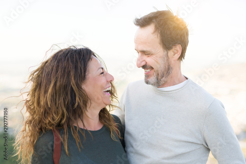 Φωτογραφία Romantic couple smiling and cuddling looking at each other on a sunny day