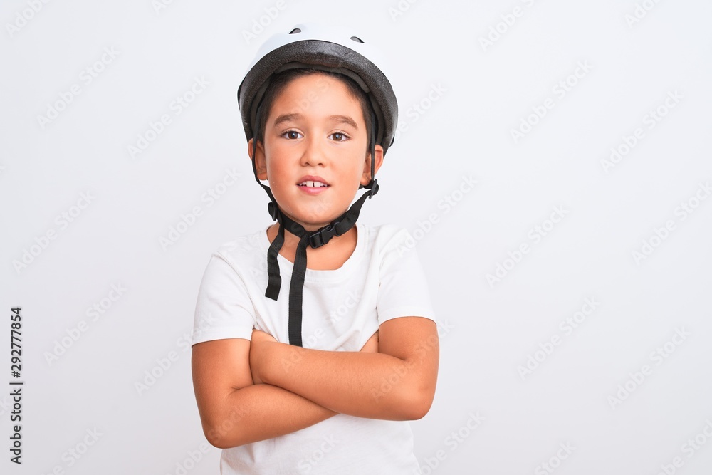 Beautiful kid boy wearing bike security helmet standing over isolated white background happy face smiling with crossed arms looking at the camera. Positive person. Beautiful kid boy wearing bike security helmet standing over isolated white background happy face smiling with crossed arms looking at the camera. Positive person.