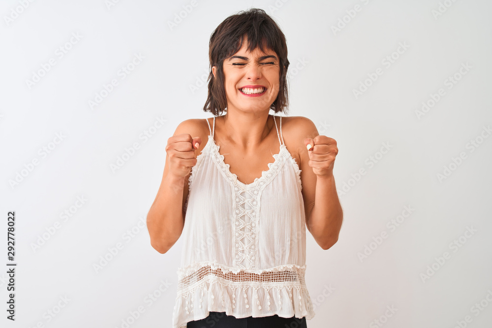 Young beautiful woman wearing summer casual t-shirt standing over isolated white background excited for success with arms raised and eyes closed celebrating victory smiling. Winner concept. Young beautiful woman wearing summer casual t-shirt standing over isolated white background excited for success with arms raised and eyes closed celebrating victory smiling. Winner concept.