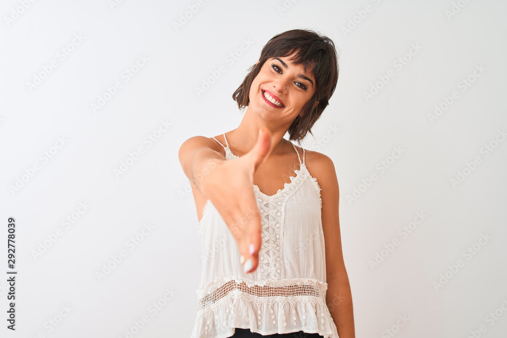 Young beautiful woman wearing summer casual t-shirt standing over isolated white background smiling friendly offering handshake as greeting and welcoming. Successful business. Young beautiful woman wearing summer casual t-shirt standing over isolated white background smiling friendly offering handshake as greeting and welcoming. Successful business.
