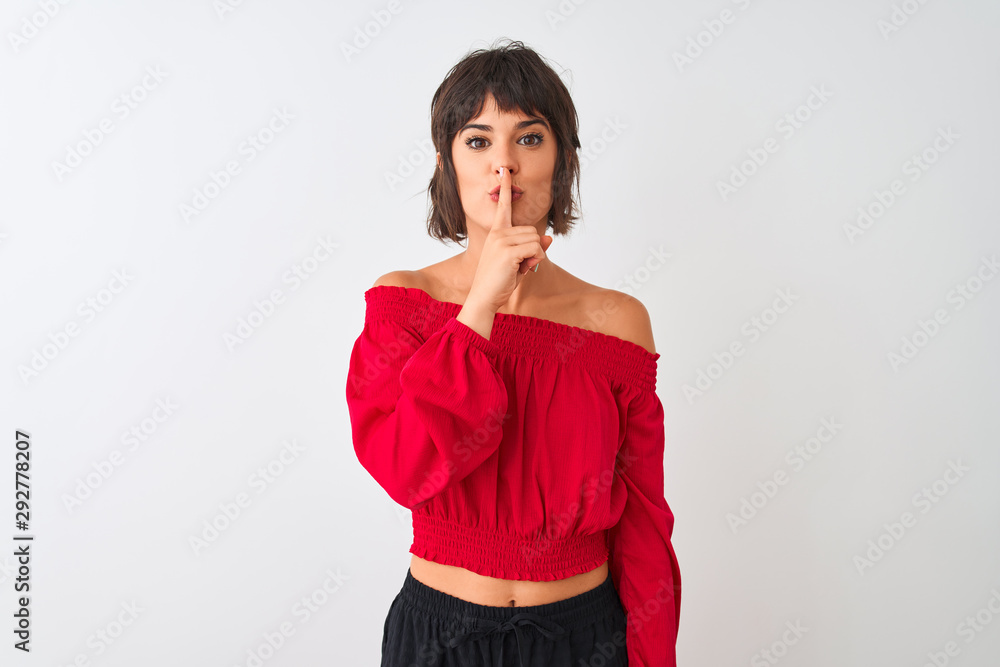Young beautiful woman wearing red summer t-shirt standing over isolated white background asking to be quiet with finger on lips. Silence and secret concept. Young beautiful woman wearing red summer t-shirt standing over isolated white background asking to be quiet with finger on lips. Silence and secret concept.
