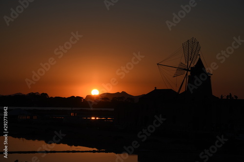 Sunset in Saline of Marsala with Windmill, Stagnone, Trapani, Sicilia. photo