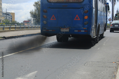 An auto bus polluting the environment with black smog coming from the exhaust pipe