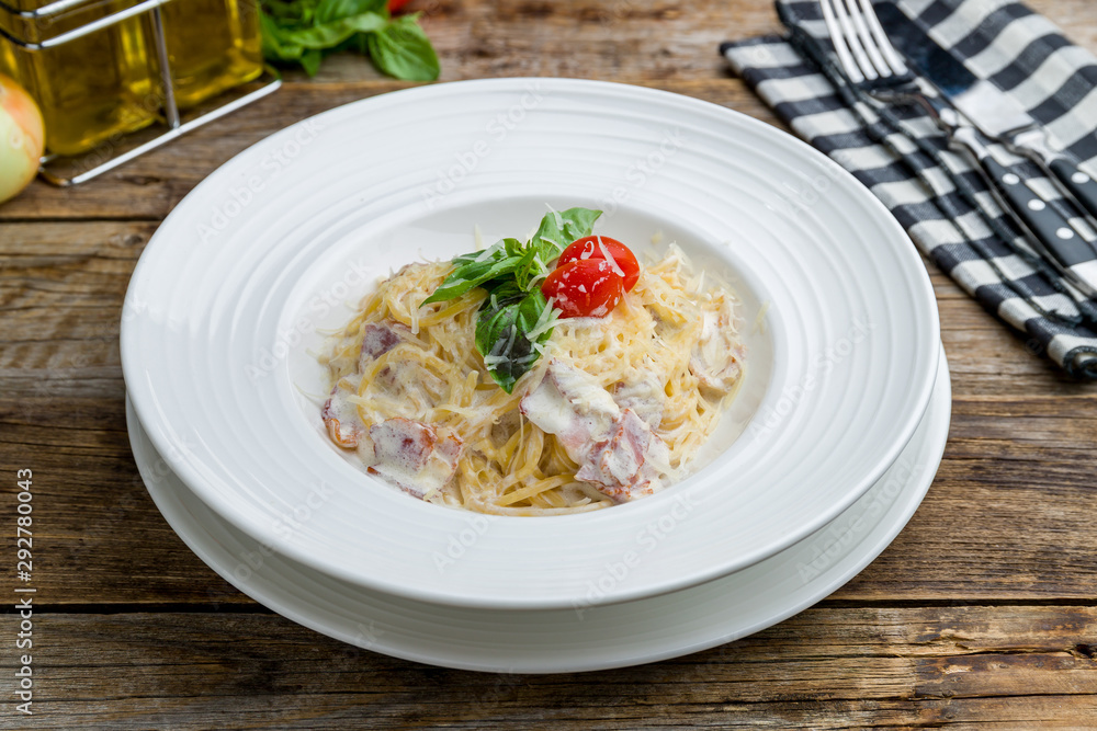 Spaghetti Carbonara with bacon on wooden table Spaghetti Carbonara with bacon on wooden table