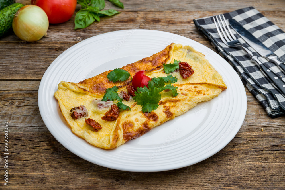 omelette breakfast on plate with sun-dried tomatoes omelette breakfast on plate with sun-dried tomatoes