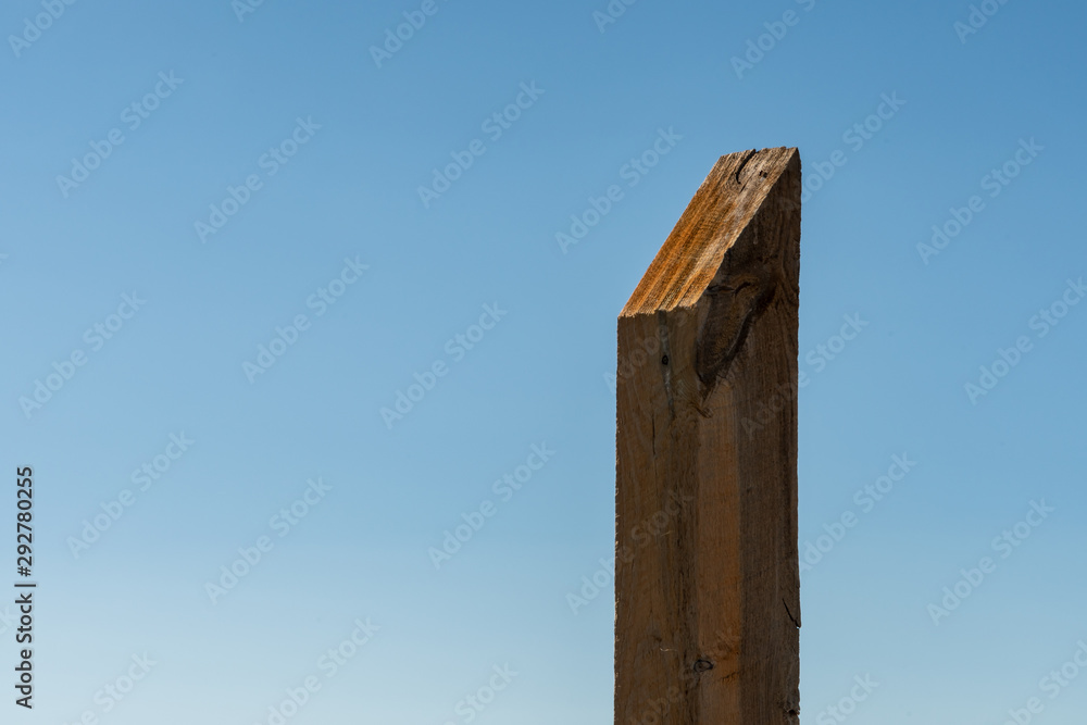 Fototapeta premium Large Wooden Trail Marker On Blue Sky