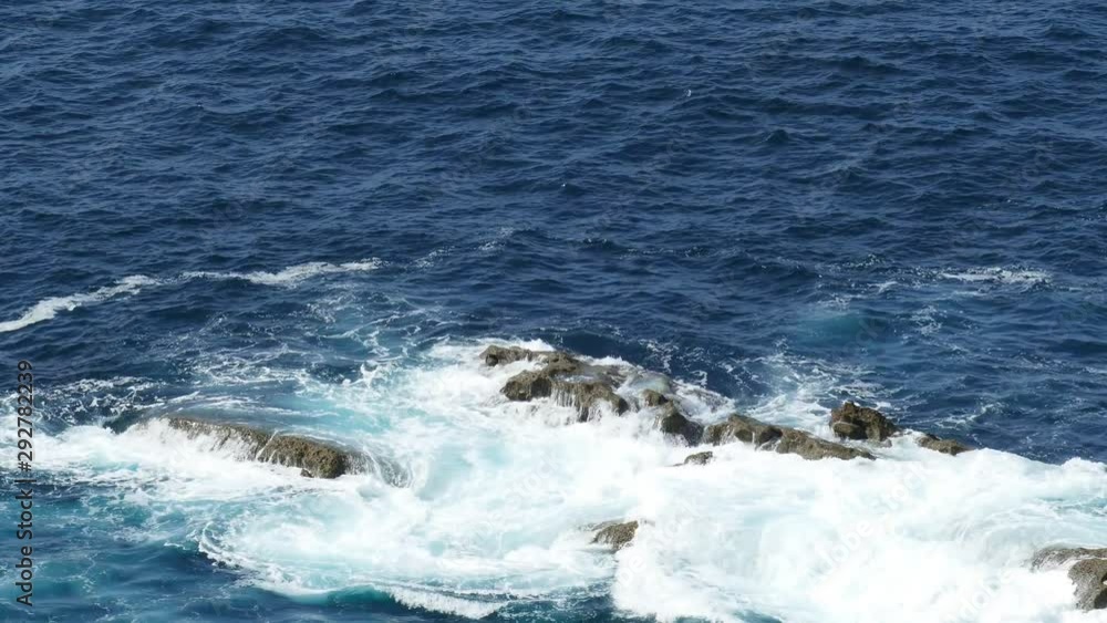 Waves crashing into rocks on the sea coast