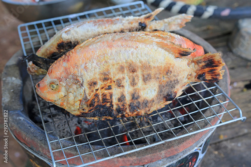 Red Tilapia fish grilled with Salt on the grill.