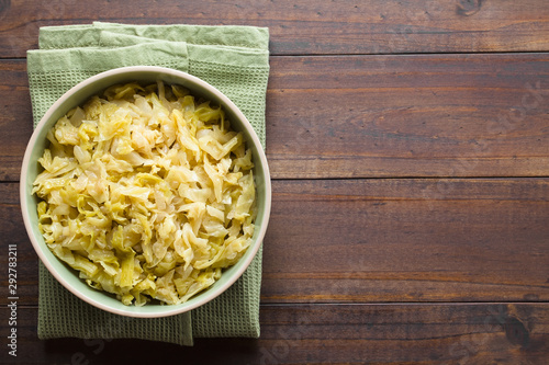 Bild auf Leinwand Fresh homemade braised white cabbage in bowl, photographed overhead with copy sp