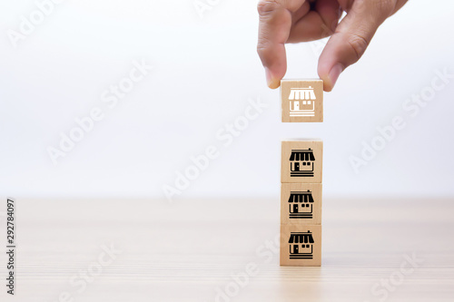 Franchise business marketing icons Store on wooden block for business growth concept.