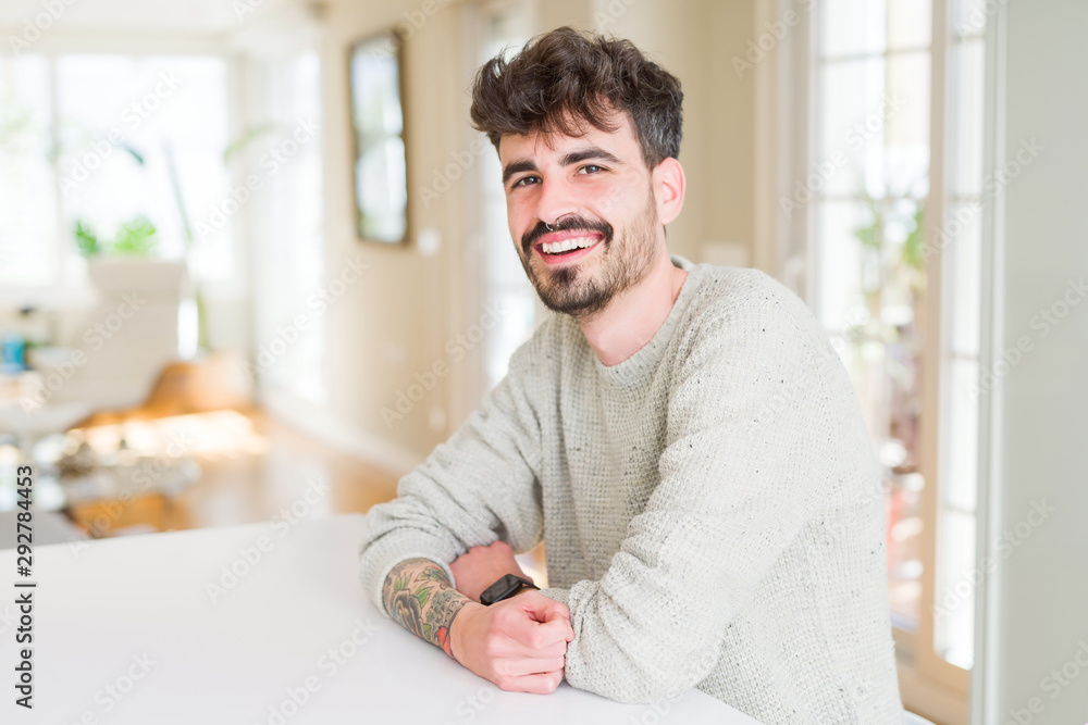Fototapeta premium Handsome young man smiling cheerful at the camera with crossed arms and a big smile on face showing teeth
