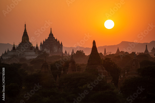Black silhouettes of temples and trees at sunset at Bagan, Burma