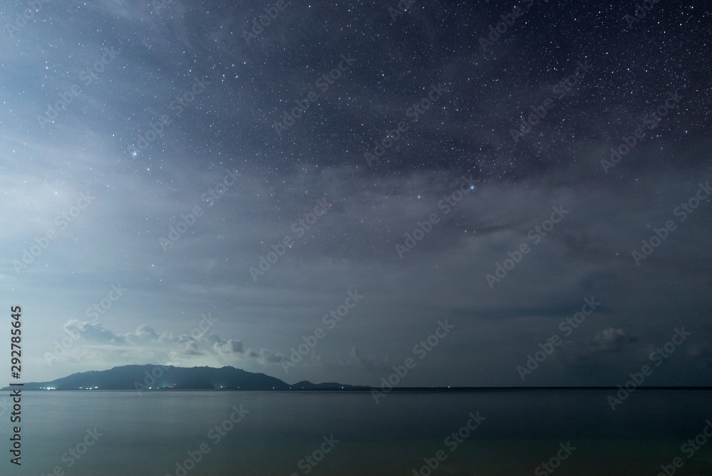 Milky Way starry sky glowing stars in the night on tropical island blurred boats in the sea Indonesia Kei Islands Moluccas Maluku Milky Way starry sky glowing stars in the night on tropical island blurred boats in the sea Indonesia Kei Islands Moluccas Maluku