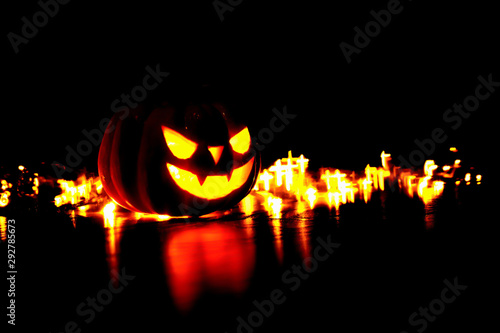 Halloween background orror magic face soft focus on dark background with bokeh of cross photo
