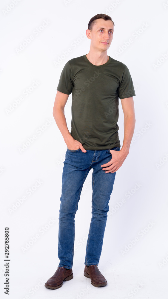 Full body shot of man thinking and looking away Full body shot of man thinking and looking away