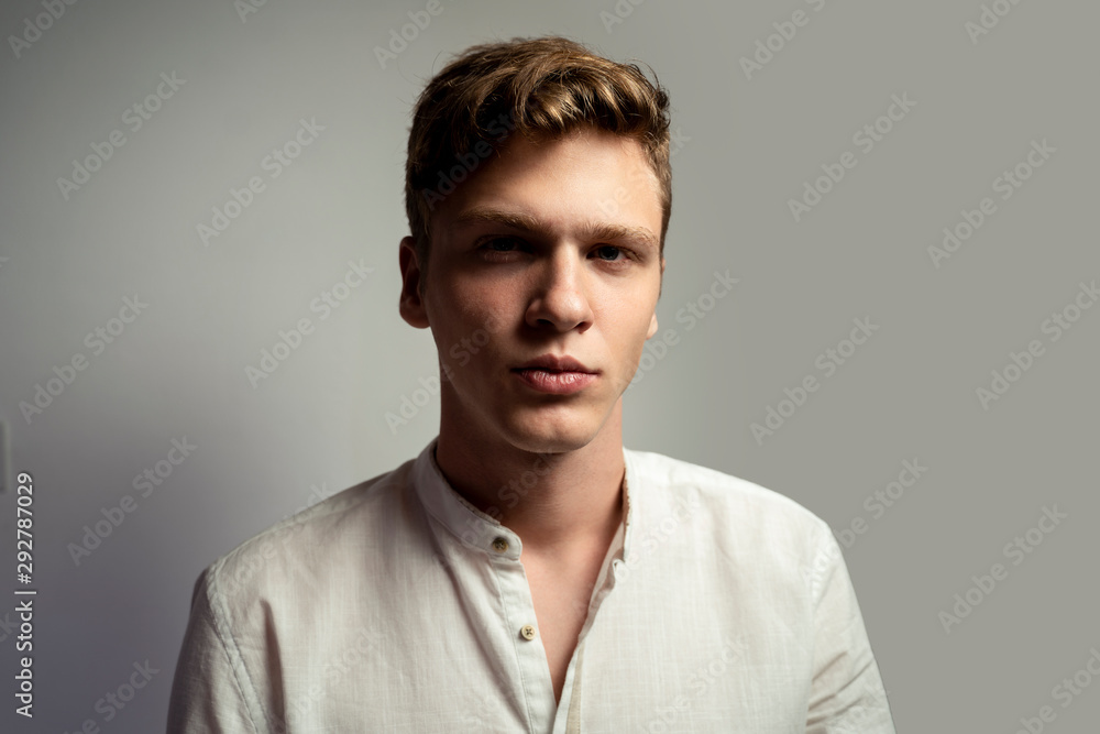 Closeup shot of teenager in white shirt, looking at camera Closeup shot of teenager in white shirt, looking at camera