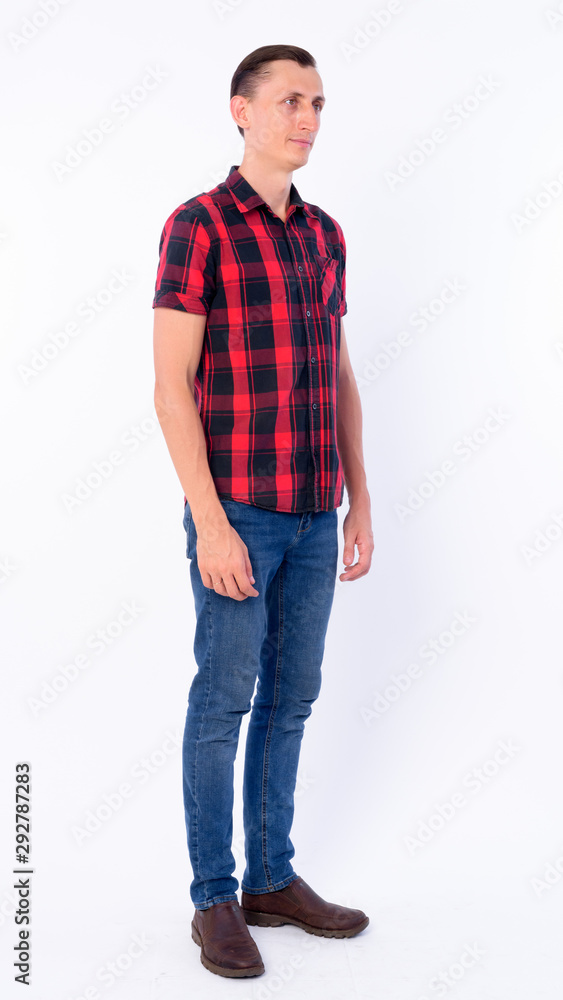 Full body shot of hipster man thinking and looking away Full body shot of hipster man thinking and looking away