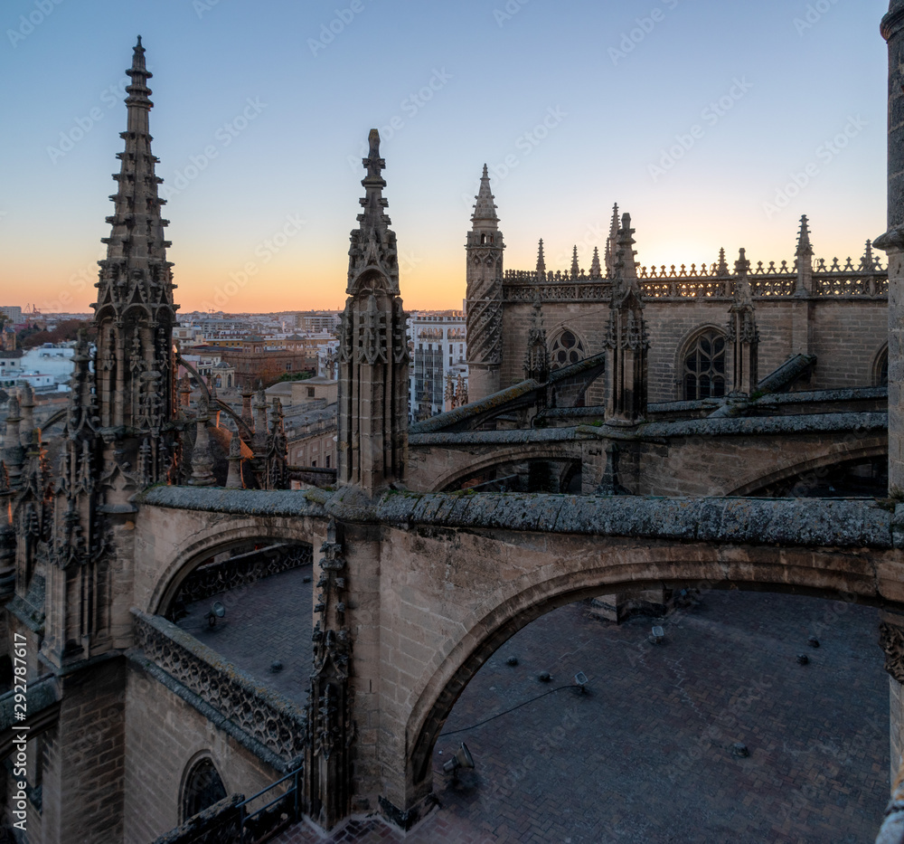The flying buttress from the roof of the cathedral of Sevilla, Spain during sunset