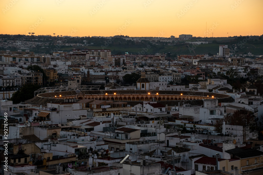 A view of the Spanish city of Sevilla during an orange sunset with the 