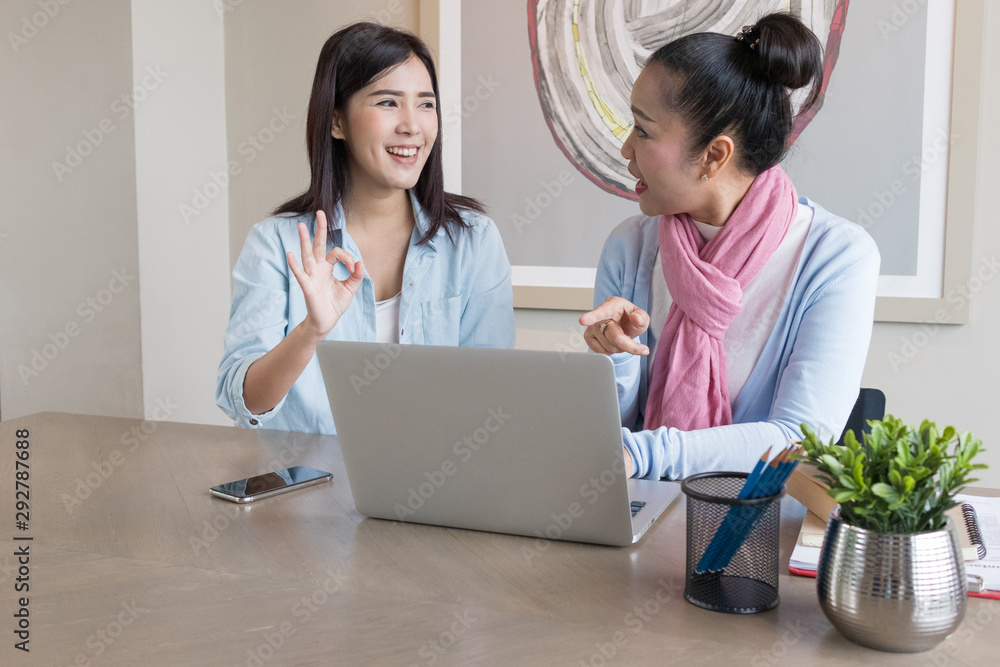 Senior woman and daughter are working at home using computers and laptops, with the internet communicating online with other people. Senior woman and daughter are working at home using computers and laptops, with the internet communicating online with other people.